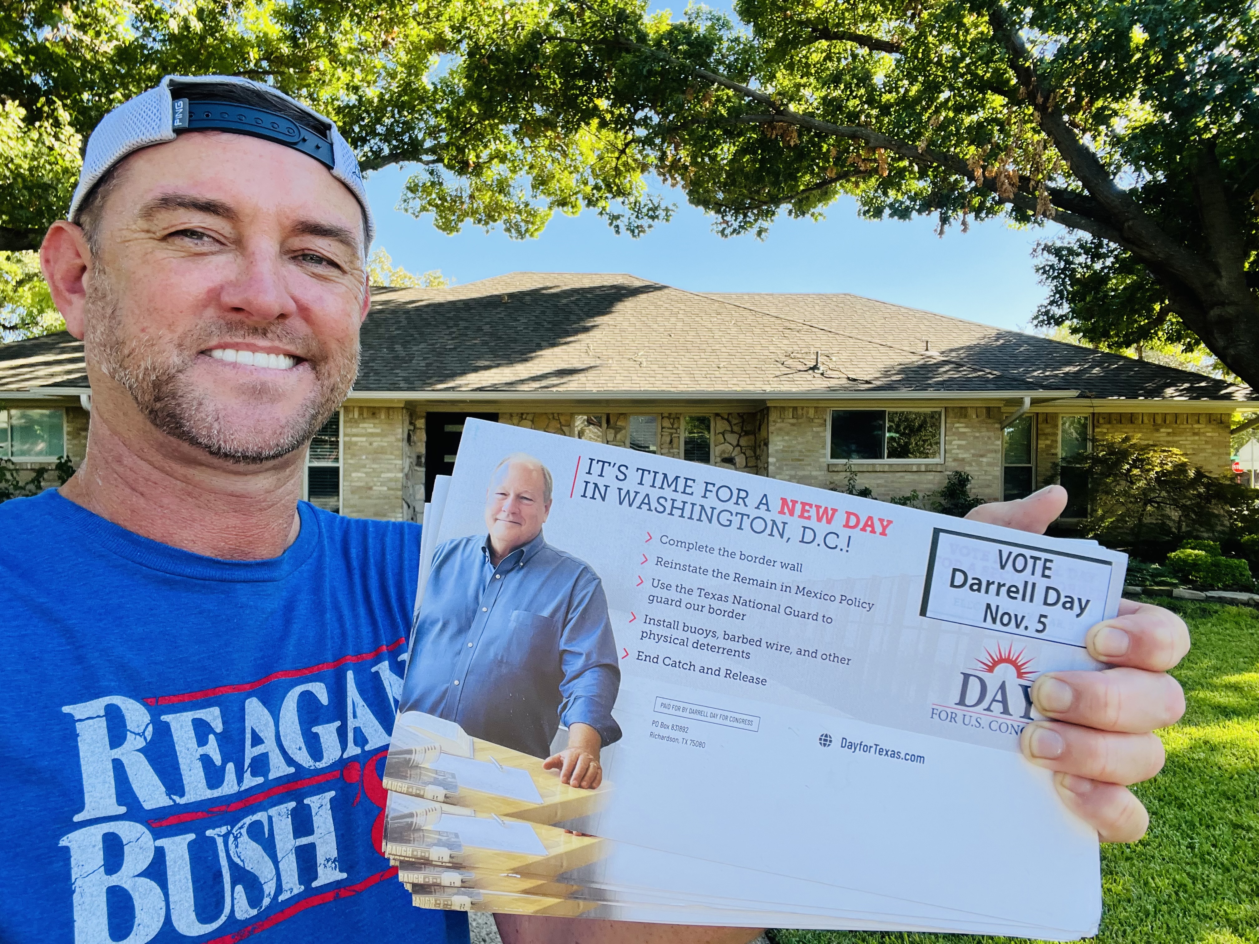 Supporter holding Darrell Day for U.S. Congress campaign mailers in a residential neighborhood in Texas District 32